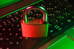 Red padlock on a dark keyboard representing an SEO security threat